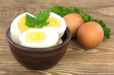 Sliced boiled eggs, with parsley leaves. Cooking a salad with boiled eggs.