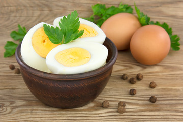 Sliced boiled eggs, with parsley leaves. Cooking a salad with boiled eggs.