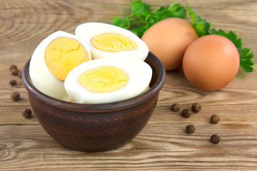 Sliced boiled eggs, with parsley leaves. Cooking a salad with boiled eggs.