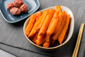 French fries with sweet plum in a white ceramic dish