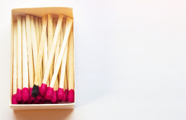 Pink matches and one match of black color in a box. Difference, self respect and acceptance concept. Copyspace on the right side of the image for designers. Uniqueness and diversity concept.