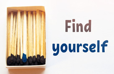 Blue matches and one match of blue color in a box. Difference, self respect and acceptance concept....