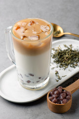 Oolong tea mixed with fresh milk in a clean glass
