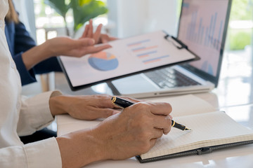 Business team brainstorming and discussing with financial data and report graph. Teamwork meeting working concept.