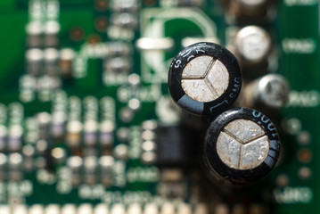 close-up circuit board with electronic components on green printed