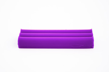 Purple plasticine on white background