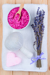 Fototapeta na wymiar spa objects soothing lavender for bath, spa and massage objects close-up view from above on a terry towel