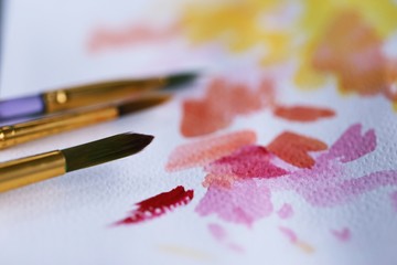 Fototapeta premium Painting brush and watercolor paper closeup