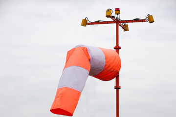 Orange-white windsock in windy weather