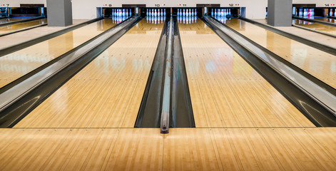Bowling wooden floor with lane, Generic Bowling Alley lanes with bowling ball going towards the pins.