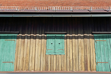 A old wooden house with green window in Salzburg, Austria, Europe
