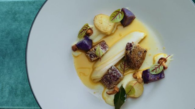 Fine dining decorated dish on a turn table, camera angle from the top. Elegance dish made by chef. luxury food.