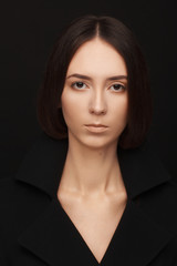 Portrait of a beautiful woman in a  black jacket. Studio photo session