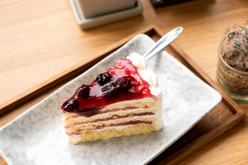 Blue berry cake on a wooden tray.