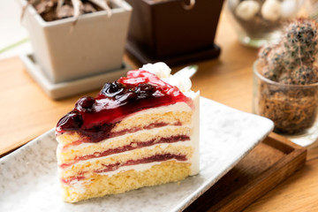 Blue berry cake on a wooden tray.