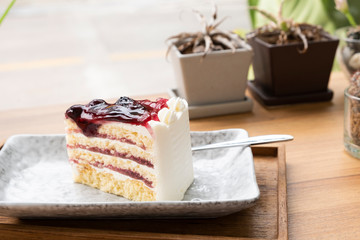 Blue berry cake on a wooden tray.
