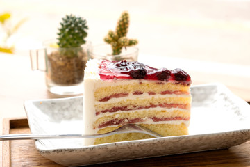Blue berry cake on a wooden tray.