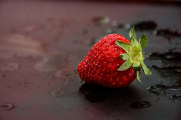one strawberry isolated on black background