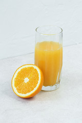 Orange juice and citrus on concrete background
