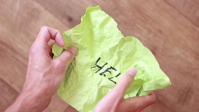 Unfolding rumpled sheet with "Help" inscription