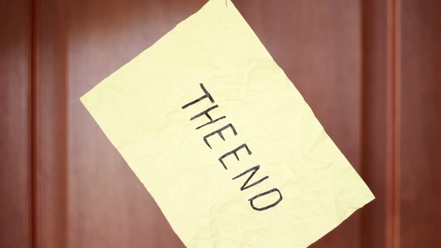 "The End" inscriprion on suspended rumpled sheet
