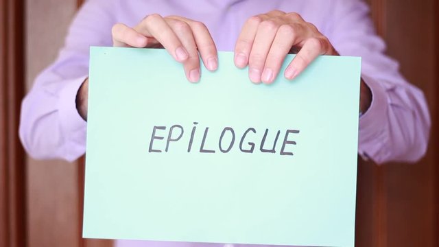 Holding "Epilogue" inscription in hands