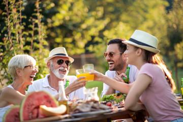 Big family have lunch in a garden