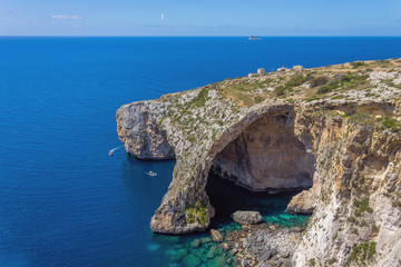 Blue Grotto rock cliff arch in Malta, aerial view from the Mediterranean Sea to the island.