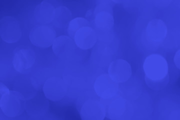 A brilliant blurry background of blue. Template for a holiday greeting card and labels with a pattern of circles with neon glitter.