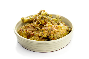 Sliced chicken with sauce in bowl on white background