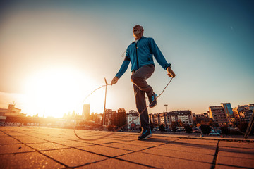 Senior man jumping rope