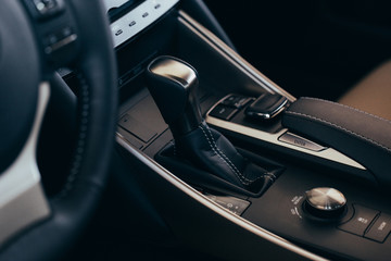 Plakat Selector automatic transmission with perforated leather in the interior of a modern expensive car. The background is blurred