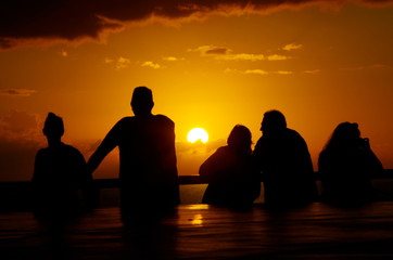 Silhouette of People watching the sunset over the Ocean from Cruise Ship