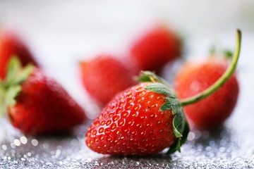 Strawberry on wooden blur macro background