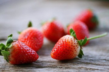 Strawberries on wooden blur macro background