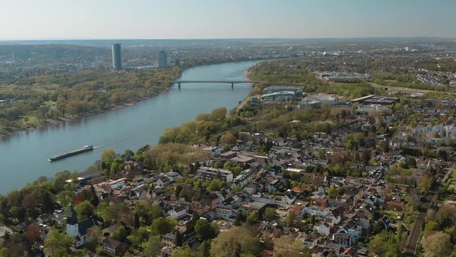Drone / Aerial panorama shot of bonn with the konrad adenauer bridge, the river rhine with a ship, the Kameha Grand hotel and the post tower 25p