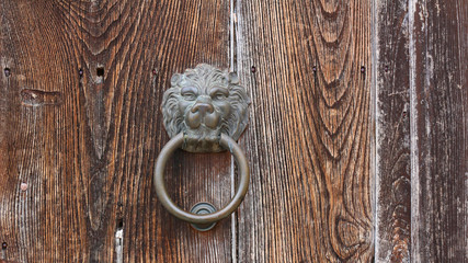Antique door knocker in the shape of a lion's head