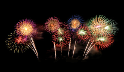 International fireworks festival display at night. Variety of colorful fireworks in holidays celebration isolated on black. Happy New Year Background. © tampatra