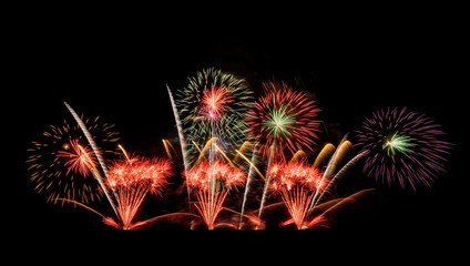 International fireworks festival display at night. Variety of colorful fireworks in holidays celebration isolated on black. Happy New Year Background. © tampatra