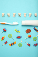 Teeth with sweet candies. Tooth caries in children's, dental healthcare, toothpaste and toothbrush.