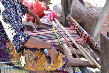 Indonesian woman in a shop producing Songket Lombok in the village Sukarara which is located in the south of the Lombok island, Indonesia