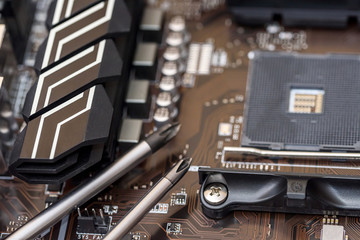 Steel spanners on motherboard of pc close up