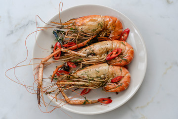 Fried king prawns with garlic and herbs, close up, Thailand
