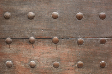 Old wooden door with nails texture background