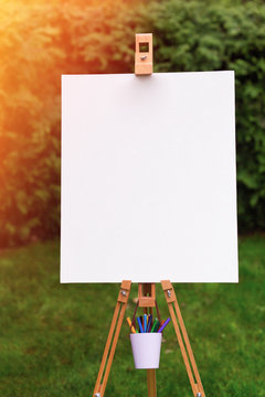 Blank easel template in the garden background
