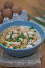 Steamed egg custard cuisine in a blue bowl with minced pork, sausage and shrimp. Or Only with egg, water, salt and some sesame oil, you can make this super smooth custard.