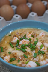 Steamed egg custard cuisine in a blue bowl with minced pork, sausage and shrimp. Or Only with egg, water, salt and some sesame oil, you can make this super smooth custard.