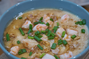 Steamed egg custard cuisine in a blue bowl with minced pork, sausage and shrimp. Or Only with egg, water, salt and some sesame oil, you can make this super smooth custard.