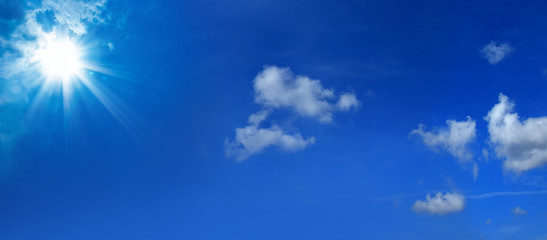 Naklejka na ściany i meble Beautiful blue sky cloudscape with shining sun