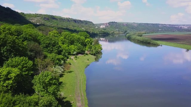 Flight over the river and forest at spring time. Dniester river of Moldova republic.